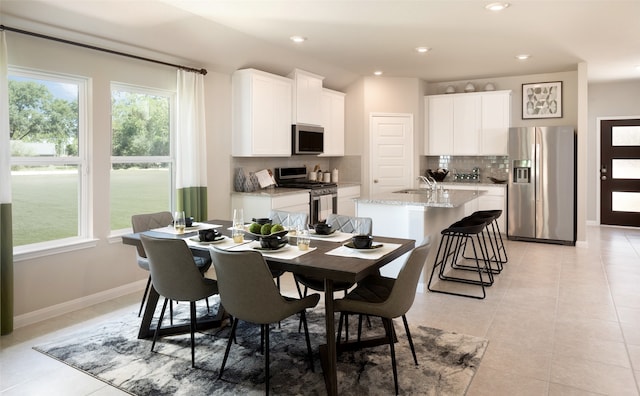 dining space with sink and light tile patterned flooring