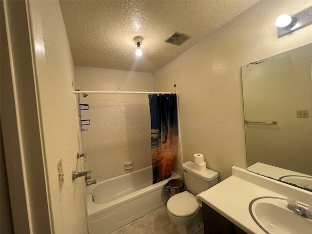 full bathroom with vanity, shower / tub combo, a textured ceiling, and toilet