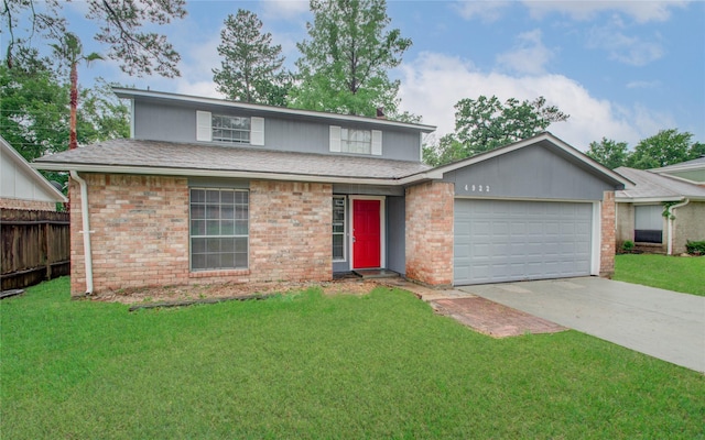 front of property featuring a front lawn and a garage