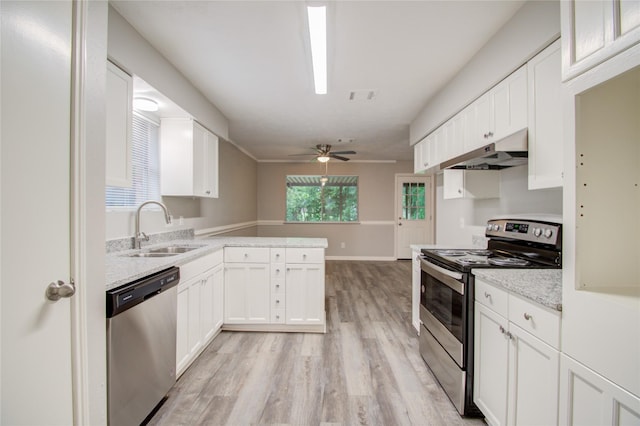 kitchen with white cabinets, light wood-type flooring, stainless steel appliances, and sink