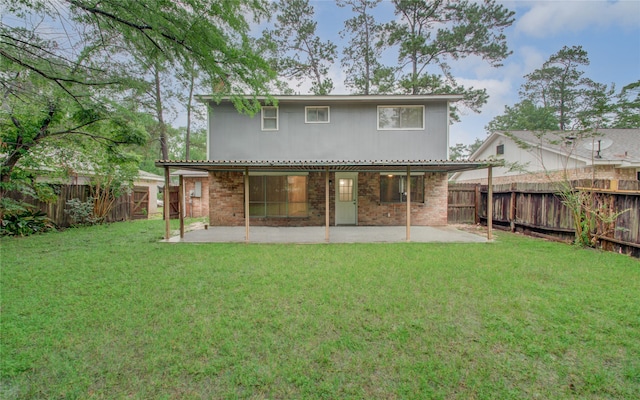 back of property with a lawn and a patio