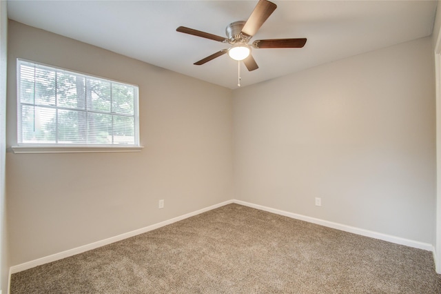 carpeted empty room featuring ceiling fan