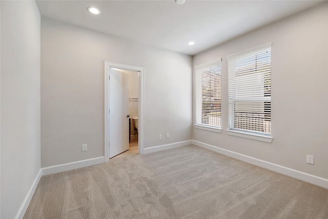 spare room with light colored carpet