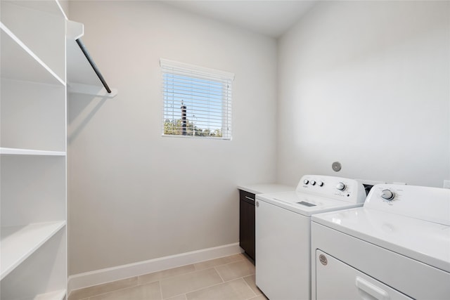 laundry room with cabinets, independent washer and dryer, and light tile patterned floors