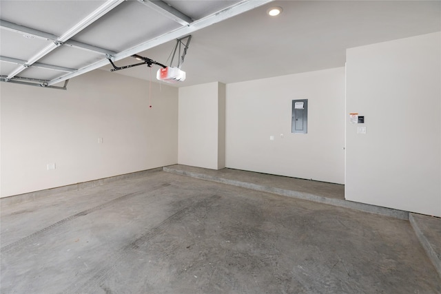 garage featuring electric panel and a garage door opener