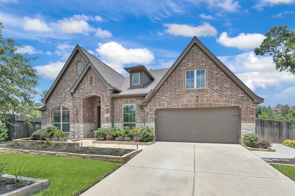 view of front of home with a front lawn and a garage