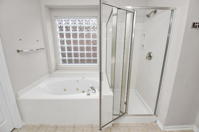 bathroom featuring tile patterned flooring and shower with separate bathtub