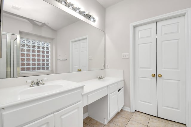 bathroom with tile patterned flooring and vanity