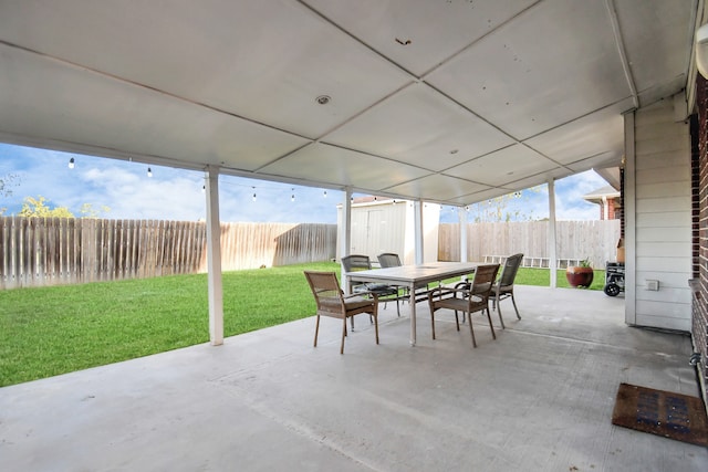 view of patio featuring a storage unit