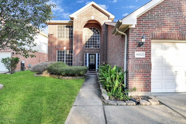 view of front property with a garage and a front lawn