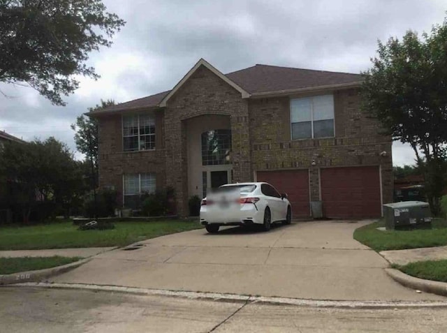 view of front property featuring a garage and a front lawn