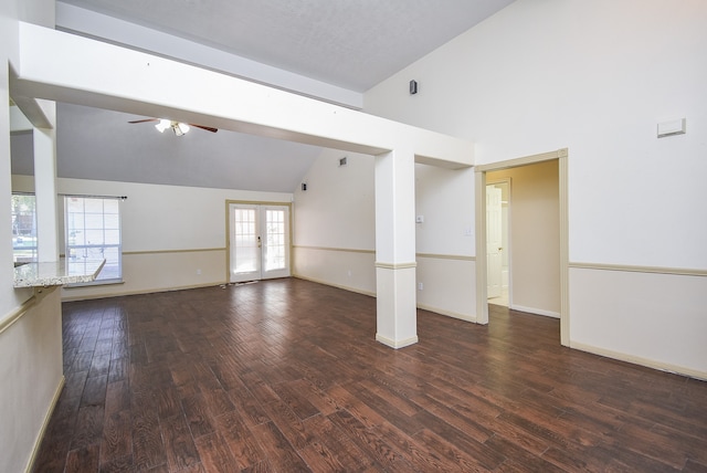 unfurnished room with dark hardwood / wood-style flooring, ceiling fan, french doors, and vaulted ceiling