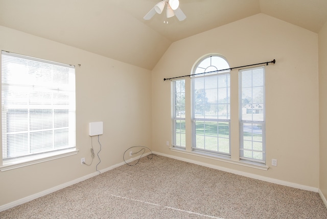 spare room featuring ceiling fan, carpet floors, and vaulted ceiling