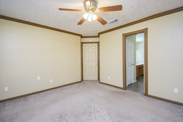 unfurnished bedroom with ceiling fan, carpet floors, a textured ceiling, and ornamental molding