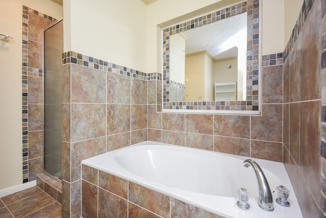 bathroom with separate shower and tub and crown molding