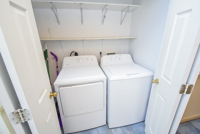 laundry room featuring light tile patterned flooring and washing machine and clothes dryer