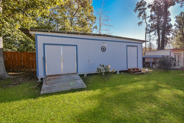 view of outdoor structure featuring a lawn