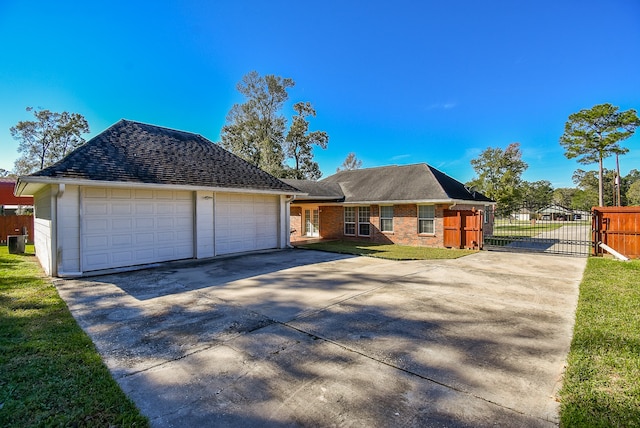 single story home with a garage and a front lawn