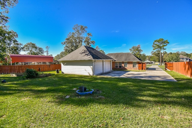 rear view of house with a yard and a garage