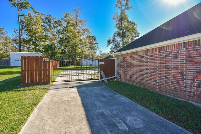 view of gate with a yard