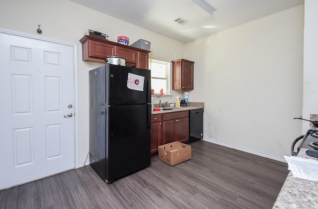 kitchen featuring sink, dark wood-type flooring, and black appliances