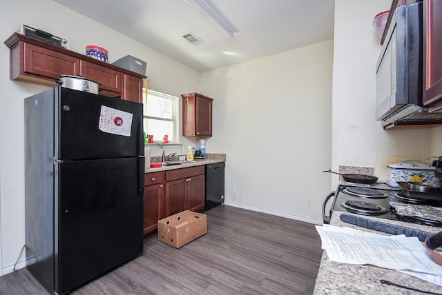 kitchen featuring black appliances, sink, and hardwood / wood-style flooring