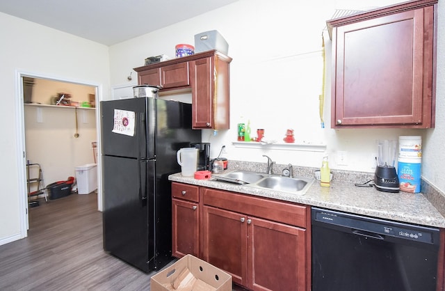 kitchen with sink, light hardwood / wood-style flooring, and black appliances