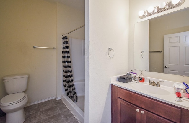 bathroom featuring tile patterned floors, vanity, curtained shower, and toilet