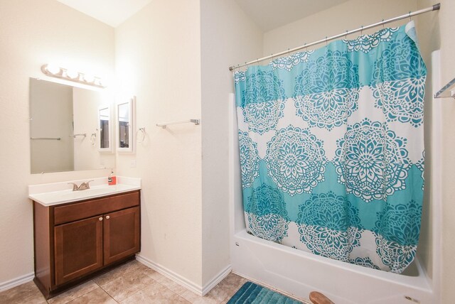 bathroom featuring vanity, tile patterned floors, and shower / bath combo with shower curtain