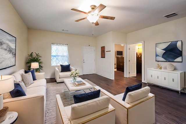 living room featuring ceiling fan and dark hardwood / wood-style flooring