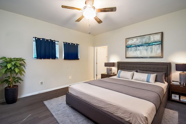 bedroom with dark hardwood / wood-style floors and ceiling fan