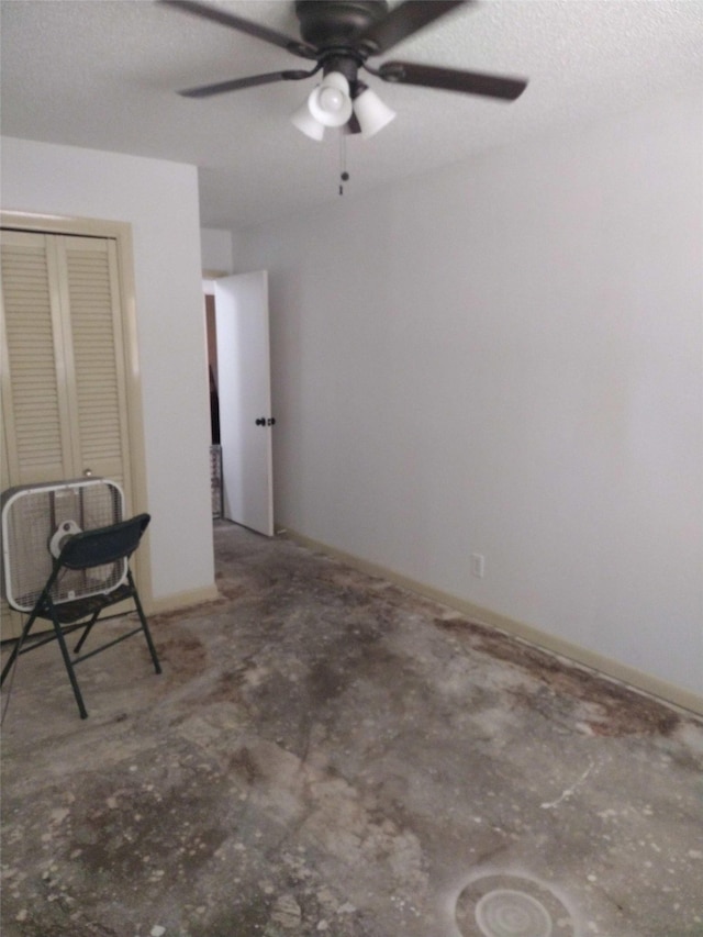 spare room featuring a textured ceiling and ceiling fan