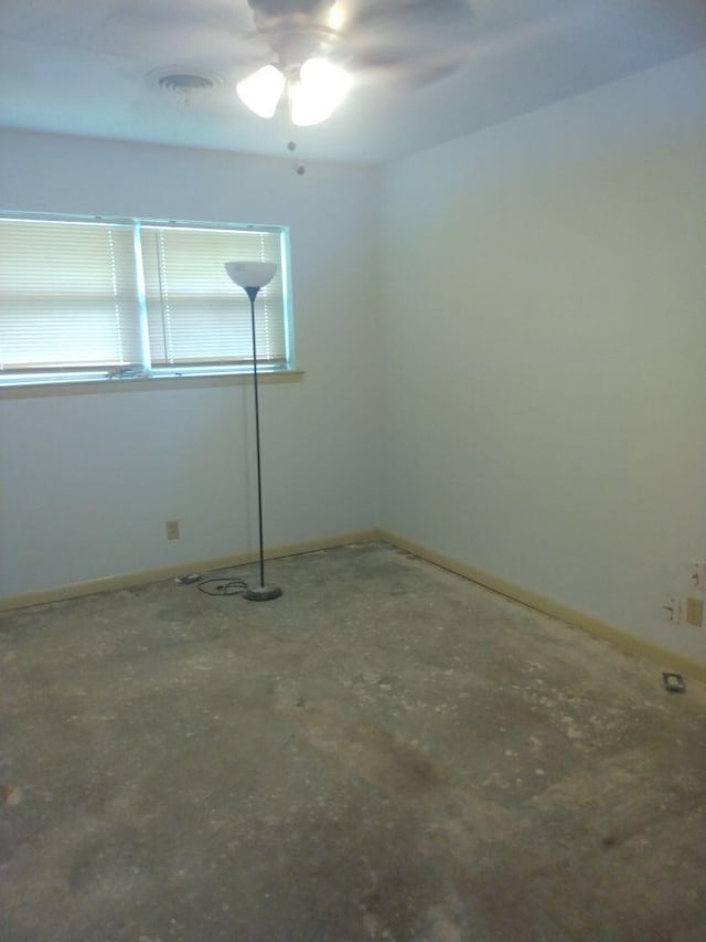 spare room with concrete floors and ceiling fan