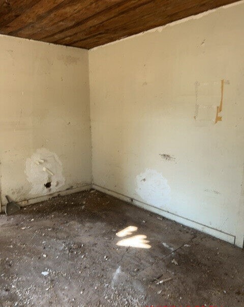 empty room featuring wooden ceiling