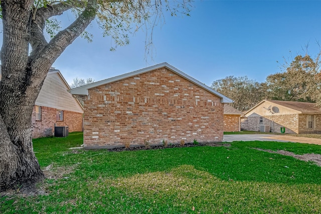 view of home's exterior featuring a lawn and central AC