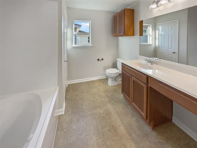 bathroom featuring a bath, vanity, toilet, and a healthy amount of sunlight