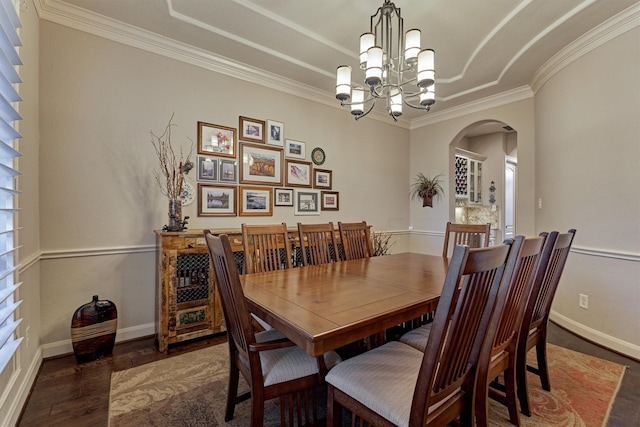 dining space featuring a healthy amount of sunlight, ornamental molding, dark wood-type flooring, and an inviting chandelier