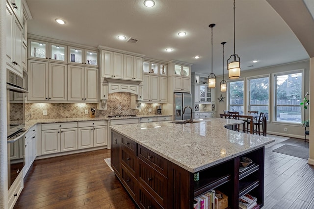 kitchen featuring stainless steel appliances, dark wood finished floors, a sink, and open shelves