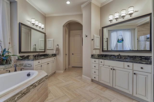 bathroom featuring vanity, ornamental molding, and tiled bath