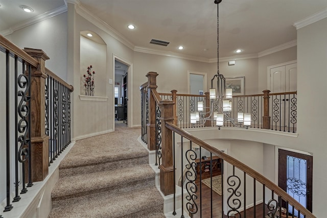 stairs featuring carpet, ornamental molding, and a notable chandelier