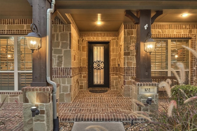 doorway to property featuring stone siding