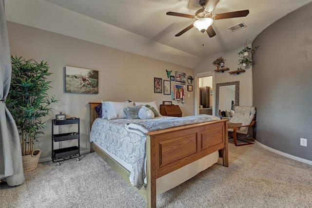 carpeted bedroom with ceiling fan and vaulted ceiling