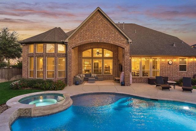 view of pool with an in ground hot tub, outdoor lounge area, a patio area, and a fenced in pool