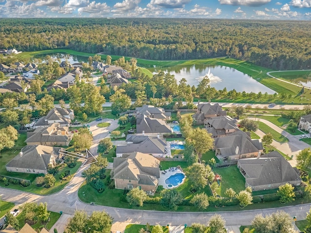 aerial view with a water view, a wooded view, and a residential view