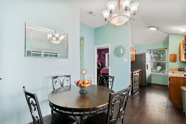 dining area featuring dark hardwood / wood-style floors, a notable chandelier, and sink