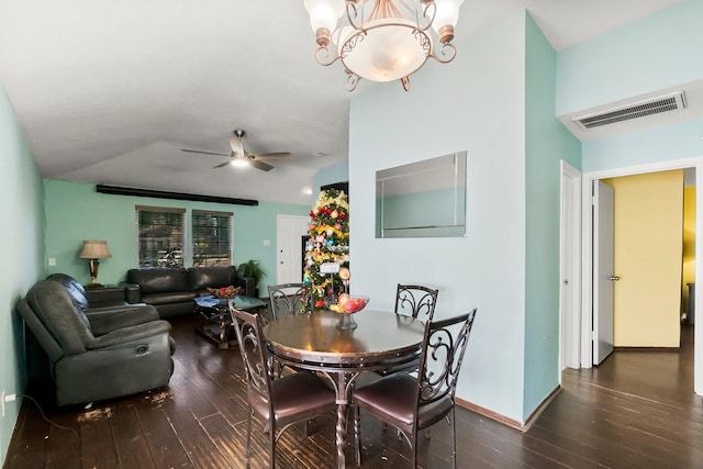 dining space featuring ceiling fan with notable chandelier and dark hardwood / wood-style flooring