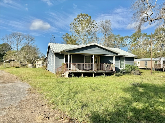 view of front of home featuring covered porch and a front yard