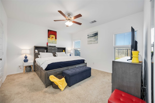 bedroom with light colored carpet and ceiling fan