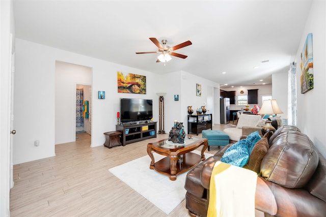 living room featuring ceiling fan and light wood-type flooring