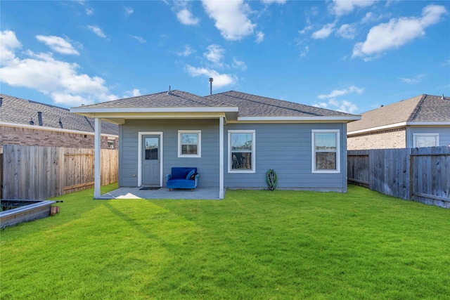 back of house featuring a patio area and a yard